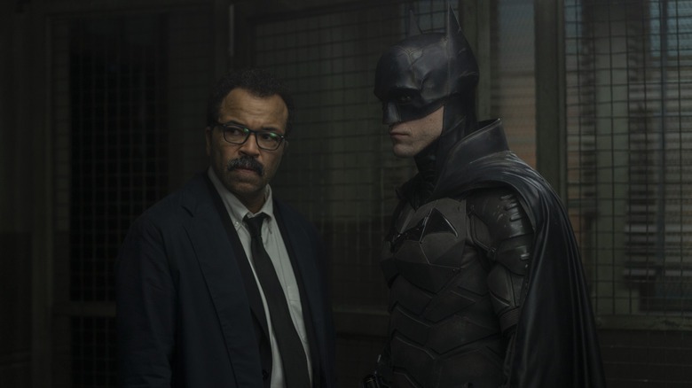 A still from a scene showing both Jeffrey Wright as Jim Gordon and Robert Patterson as Batman, observing a scene