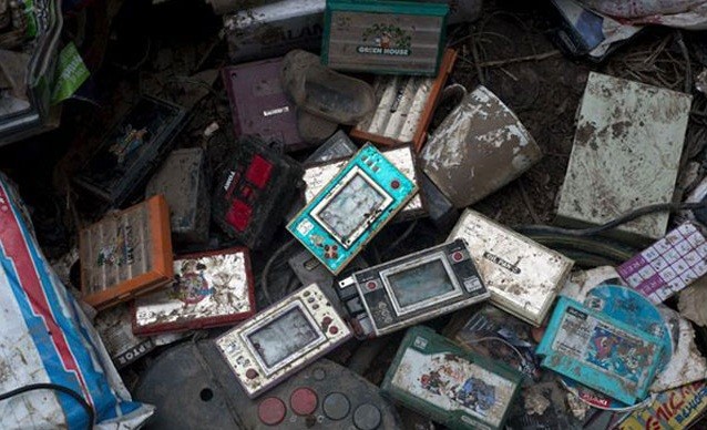 a pile of wrecked retro consoles